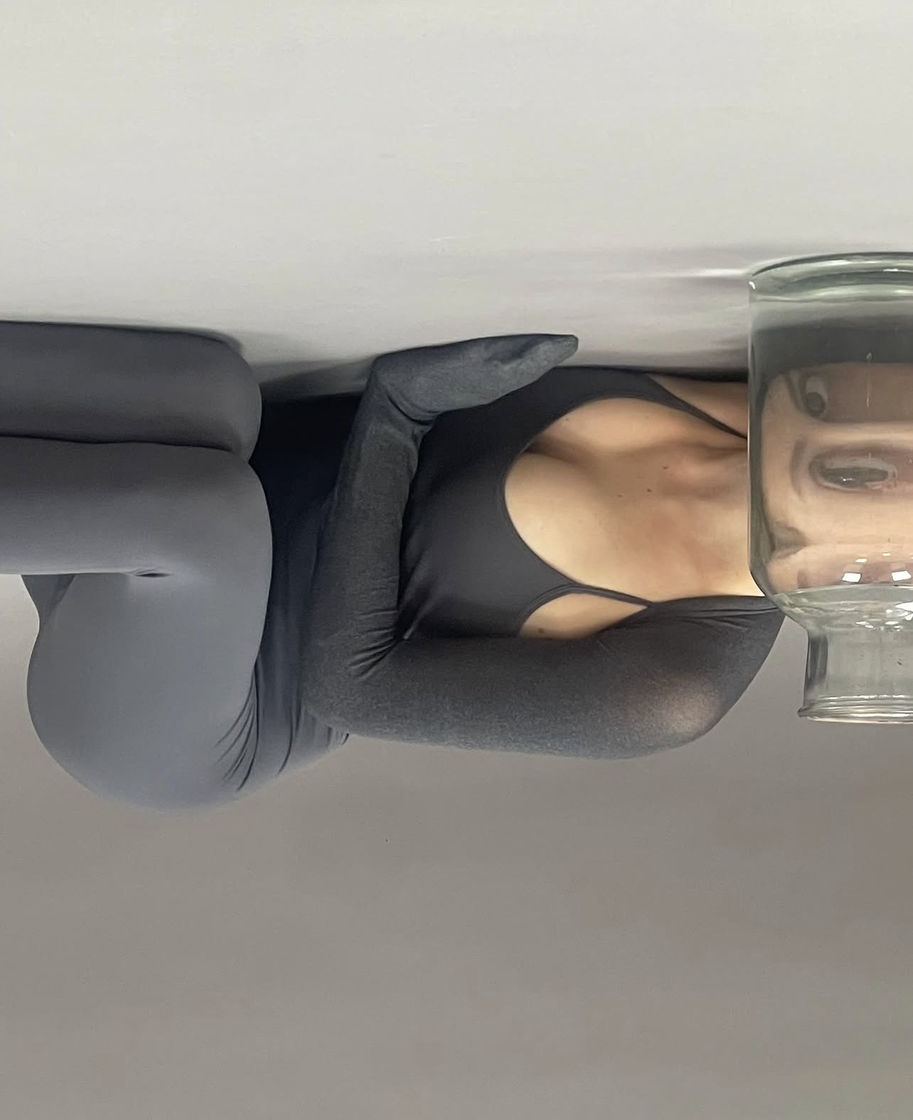 Upside-down frame of the model, face seen through the jar